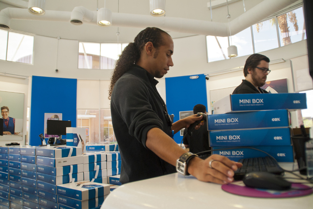 David Harper helps a customer get four mini-boxes at the Cox Solutions Store near Centennial Center Boulevard and Tropical Parkway in Las Vegas on Wednesday, Aug. 31, 2016. Customers have been pic ...