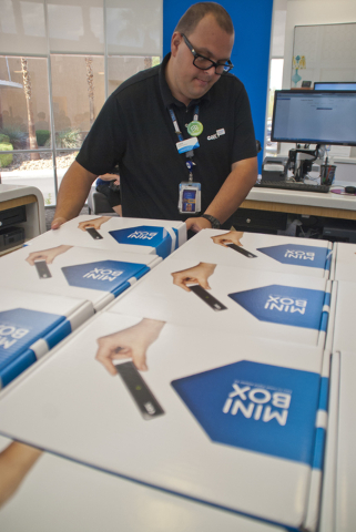 John King grabs two mini-boxes for a customer at the Cox Solutions Store near Centennial Center Boulevard and Tropical Parkway in Las Vegas on Wednesday, Aug. 31, 2016. Customers have been picking ...