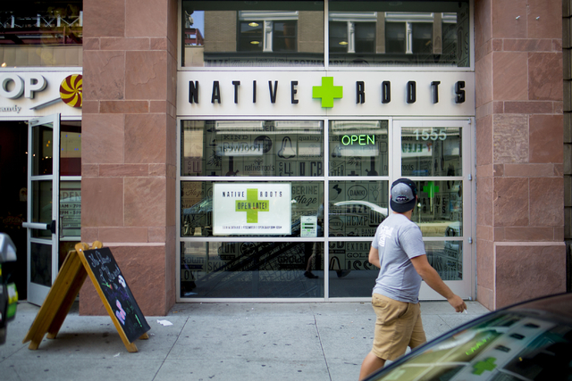 A pedestrian walks passed Native Roots Dispensary where different forms of recreational marijuana can be purchased in Denver Colorado, Wednesday, Aug. 31, 2016. Elizabeth Page Brumley/Las Vegas Re ...