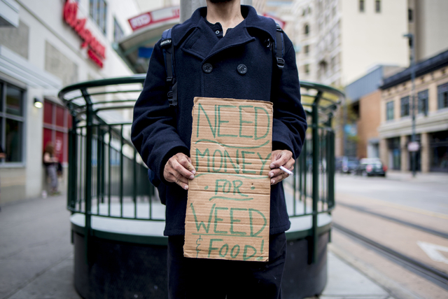 A man stands on the 16th st. mall holding a sign asking for both money and weed Friday, Aug. 2, 2016, in Denver Colorado. Elizabeth Page Brumley/Las Vegas Review-Journal Follow @ELIPAGEPHOTO