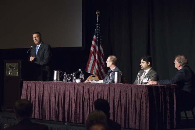 Gov. Brian Sandoval, left, speaks during his Prescription Drug Abuse Prevention Summit at MGM Grand hotel-casino in Las Vegas, Wednesday, Aug. 31, 2016. Scott Pattison, executive director with the ...