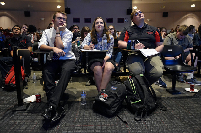 UNLV students from left, Matthew Gomez, Ember Smith and Tom Gliniecki watch the presidential debate during an event at UNLV Monday, Sept. 26, 2016, in Las Vegas. Several hundred college, middle an ...