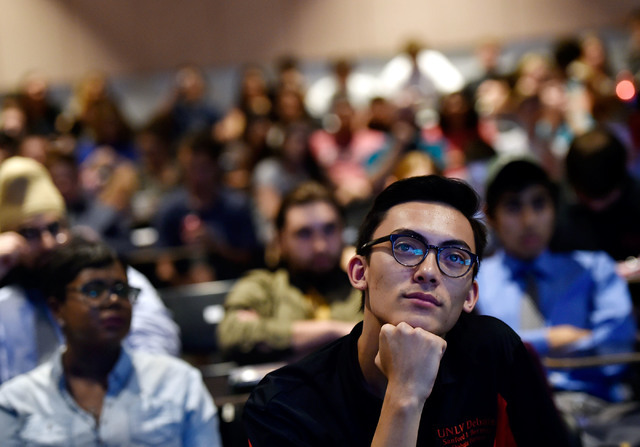 UNLV students Christian Ogata watches the presidential debate during an event at UNLV Monday, Sept. 26, 2016, in Las Vegas. Several hundred college, middle and high school debate students watched  ...