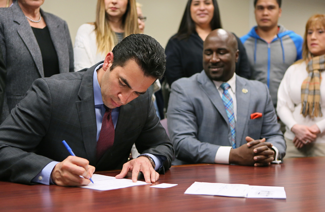 Democratic state Sen. Ruben Kihuen, left, fills out paperwork to file with the Secretary of State's office for the 4th Congressional District race Monday, March 7, 2016, in Las Vegas. Councilman R ...