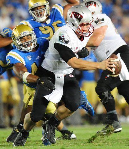 UCLA Bruins linebacker Kenny Young (42) sacks UNLV Rebels quarterback Johnny Stanton (4) in the second half of their NCAA college football game at the Rose Bowl in Pasadena, Calif. Saturday Sept. ...