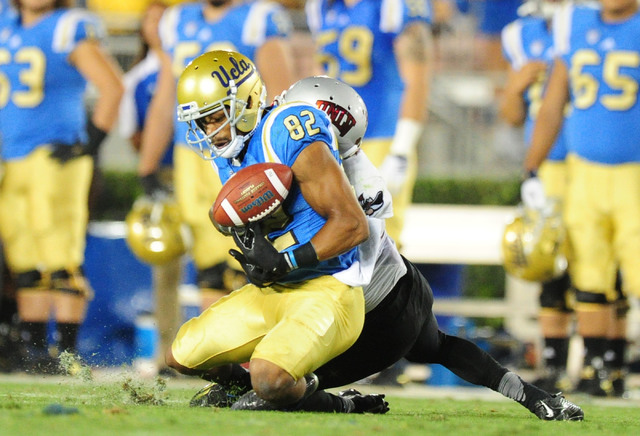UCLA Bruins wide receiver Eldridge Massington (82) is unable to catch a pass while UNLV Rebels defensive back Darius Mouton (21) defends in the second half of their NCAA college football game at t ...