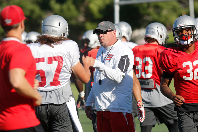 UNLV football coach Tony Sanchez, center, talks with a player during practice at Rebel Park in Las Vegas, Tuesday, Sept. 13, 2016. (Chitose Suzuki/Las Vegas Review-Journal)