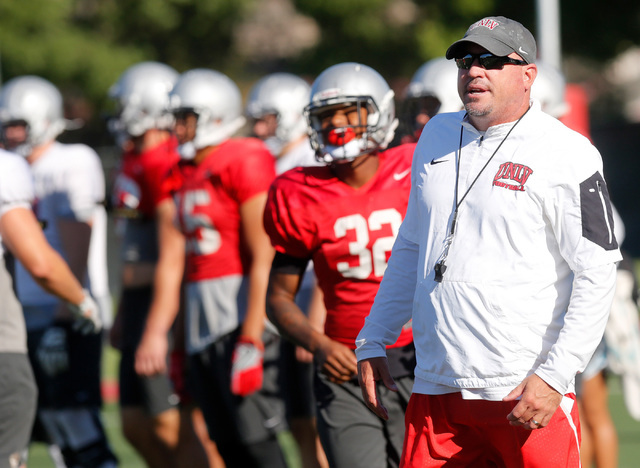 UNLV football coach Tony Sanchez, right, watches a team drill during practice at Rebel Park in Las Vegas, Tuesday, Sept. 13, 2016. (Chitose Suzuki/Las Vegas Review-Journal)
