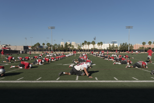 Players stretch during football practice at UNLV's Rebel Park in Las Vegas, Tuesday, Sept. 27, 2016. (Jason Ogulnik/Las Vegas Review-Journal)