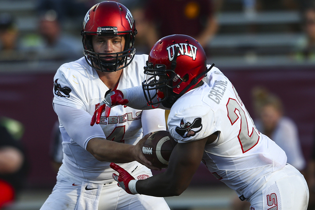UNLV quarterback Johnny Stanton (4) hands the ball off to UNLV running back David Greene (22) during a football game at Kelly/Shorts Stadium in Mount Pleasant, Mich. on Saturday, Sept. 17, 2016. C ...