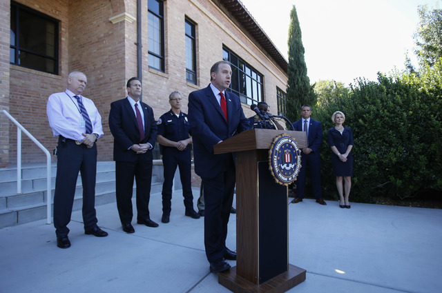 FBI Special Agent in Charge Aaron Rouse is joined by various other law enforcement agencies as he addresses members of the media during a press conference outside the main entrance of City Hall in ...
