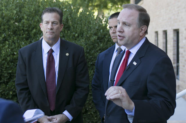 FBI Special Agent in Charge Aaron Rouse, right, responds to a reporter's question during a press conference outside the main entrance of City Hall in Boulder City on Friday, Sept. 16, 2016. (Richa ...