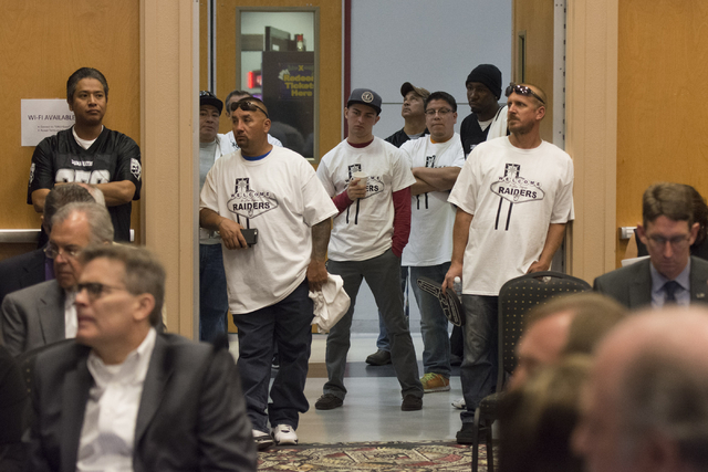 Raiders supporters watch during a Southern Nevada Tourism Infrastructure committee meeting at UNLV in Las Vegas to discuss the proposed $1.9 billion, 65,000-seat, domed stadium on Thursday, Sept.  ...