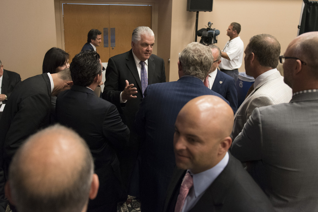 Southern Nevada Tourism Infrastructure committee member Steve Sisolak, center, speaks with committee members while on a break during a Southern Nevada Tourism Infrastructure committee meeting at U ...