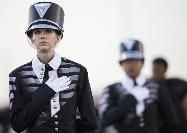 The Silverado marching band observes the National Anthem before the start of the Skyhawks home matchup with the Faith Lutheran Crusaders on Friday, Sept. 16, 2016, at Silverado High School, in Las ...