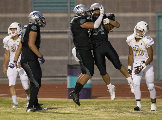 Silverado running back Keikiokalani Misipeka (34) celebrates with teammates after scoring a first quarter touchdown during the Skyhawks home matchup with the Faith Lutheran Crusaders on Friday, Se ...