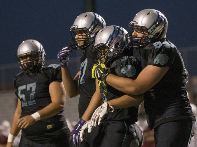 Silverado running back Keikiokalani Misipeka (34) celebrates with teammates after scoring a first quarter touchdown during the Skyhawks home matchup with the Faith Lutheran Crusaders on Friday, Se ...