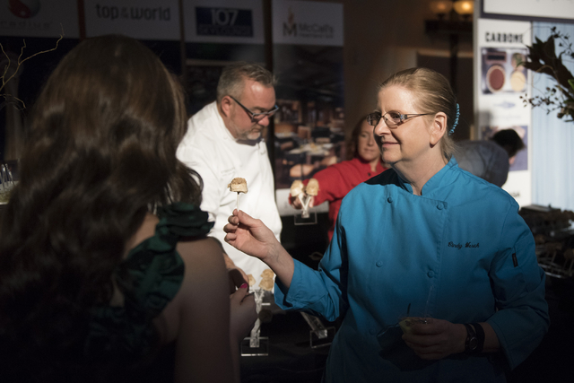 Pastry chef with Stratosphere hotel-casino Cynthia Werth, right, talks with guests about her dessert entry during the Girl Scouts of Southern Nevada &quot;Dessert Before Dinner&quot; chari ...