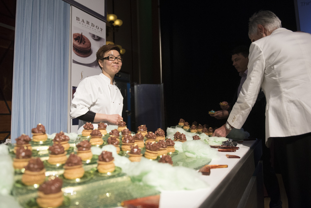 Pastry chef with Aria hotel-casino Kyurim Lee, left, speaks with guests about her dessert entry during the Girl Scouts of Southern Nevada &quot;Dessert Before Dinner&quot; charity event at ...