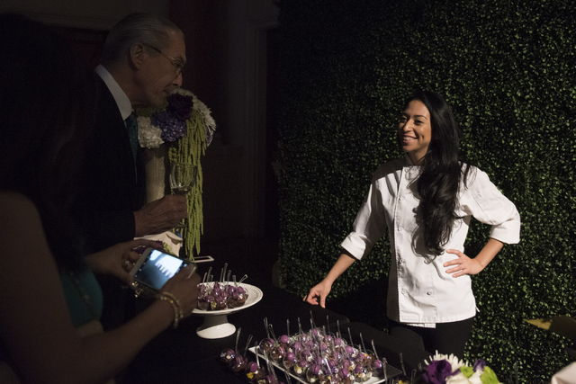 Pastry chef with STK Las Vegas Brigette Contreras speaks with guests about her dessert entry during the Girl Scouts of Southern Nevada &quot;Dessert Before Dinner&quot; charity event at Ca ...