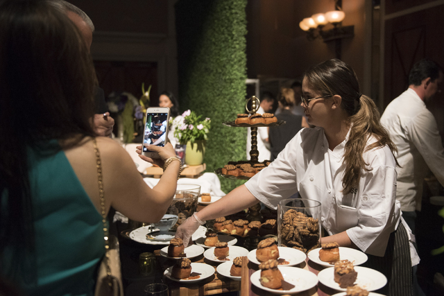 Pastry chef with Andiron Steak & Sea Samara Sulin, right, speaks with guests about her dessert entry during the Girl Scouts of Southern Nevada &quot;Dessert Before Dinner&quot; charity ...
