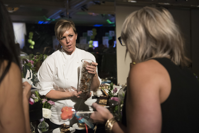 Pastry chef with Wynn Resorts Elizabeth Stolarick, left, speaks with guests about her dessert entry during the Girl Scouts of Southern Nevada &quot;Dessert Before Dinner&quot; charity even ...