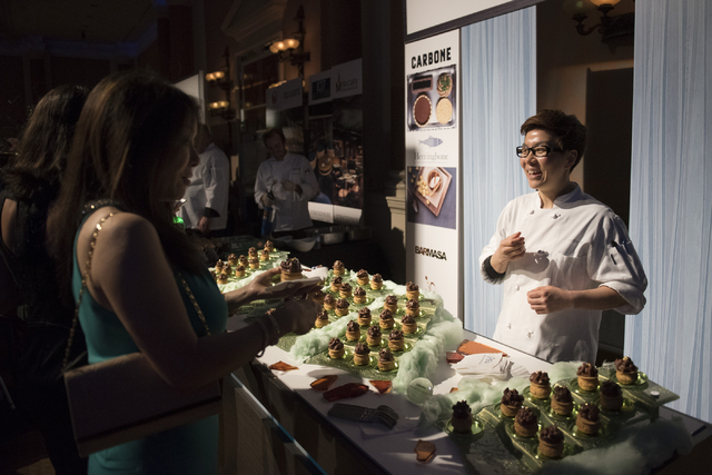 Pastry chef with Aria hotel-casino Kyurim Lee, right, speaks with guests about her dessert entry during the Girl Scouts of Southern Nevada &quot;Dessert Before Dinner&quot; charity event a ...