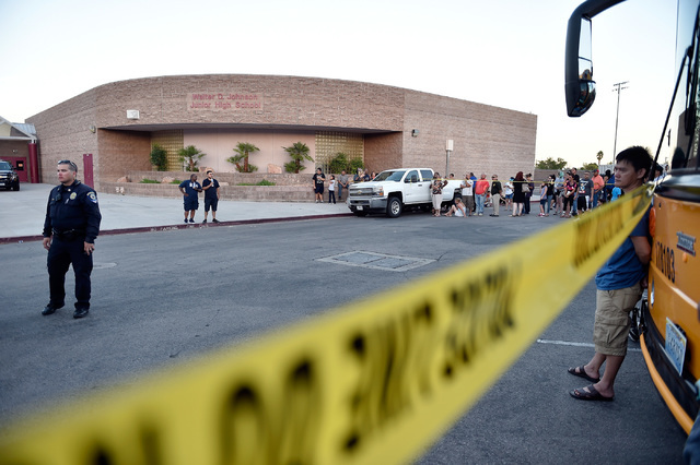 Parents wait for their children to be released from Johnson Junior High School after a hazardous material, suspected to be mercury, was found in the schoolճ gymnasium Wednesday, Sept. 7, 201 ...