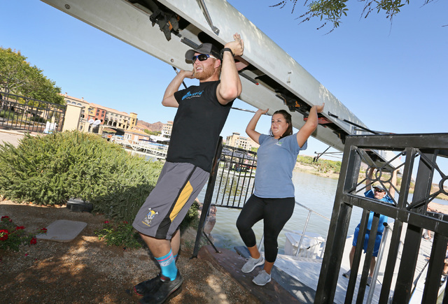 Crew members, from left, Daniel Chapman, Taylor Gangi and Matt McKnight carry the boat back to the boathouse after rowing at Lake Las Vegas Sept. 17. Crew coach Jim Andersen plans to lead competit ...