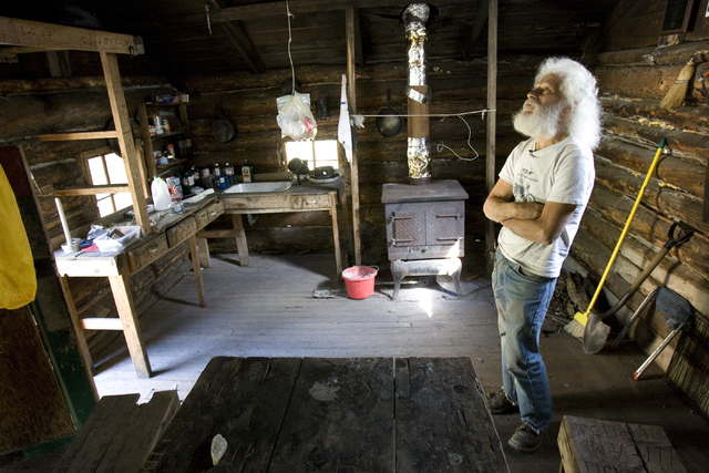 Kent Olson, 68, a historic log cabin restoration expert, checks out the Hidden Forest Cabin in the Sheep Mountains north of Las Vegas Tuesday, May 12, 2009. K.M. Cannon/Las Vegas Review-Journal Fo ...