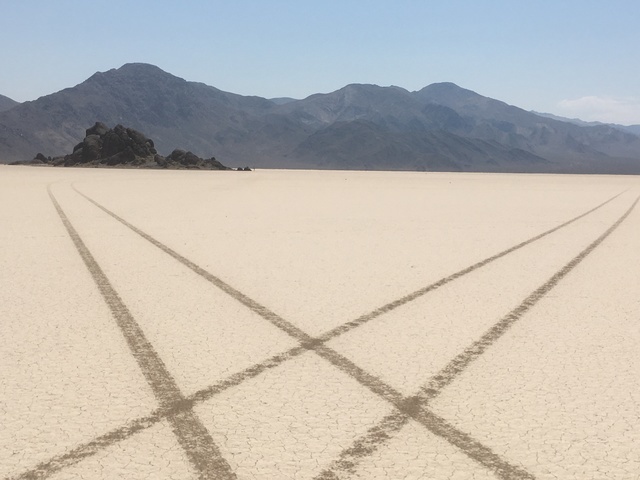 In this undated photo from Death Valley National Park, tire tracks from an illegal joyride crisscross Racetrack Playa near a formation called the Grandstand. (Courtesy of the National Park Service)