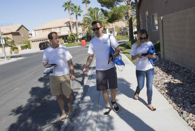 Tim Phillips, left, president of Americans for Prosperity, is joined by Field Director Erinn Mahathey, right and volunteer Roger Pattison as they canvass a neighborhood for the organization in wes ...