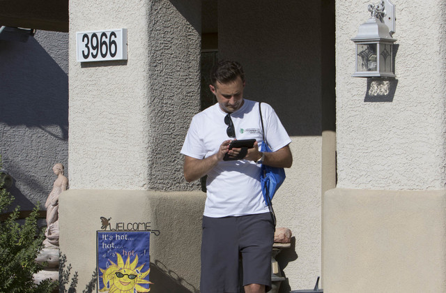 Americans for Prosperity volunteer Roger Pattison updates his route while going door-to-door for the organization in a neighborhood in west Las Vegas on Monday, Aug. 29, 2016. (Richard Brian/Las V ...