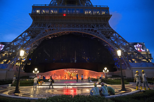 People walk in front of the half-scale Eiffel Tower at the Parisian Macau hotel-casino in Macau on Saturday, Sept. 10, 2016. The Parisian resort is set to open Tuesday. Erik Verduzco/Las Vegas Rev ...