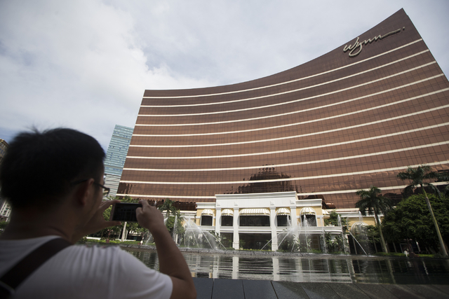 A man takes a photo of the fountain show at the Wynn Macau hotel-casino on Sunday, Sept. 11, 2016, in Macau. Erik Verduzco/Las Vegas Review-Journal Follow @Erik_Verduzco