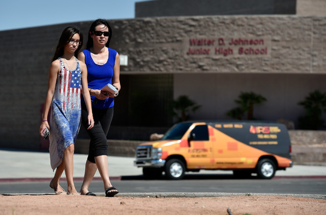 Ching Vogl, right, and her daughter, Fiona Vogl, leave Johnson Junior High School Monday, Sept. 12, 2016, in Las Vegas. The two left empty-handed after discovering that Fiona's backpack, lunchbox  ...