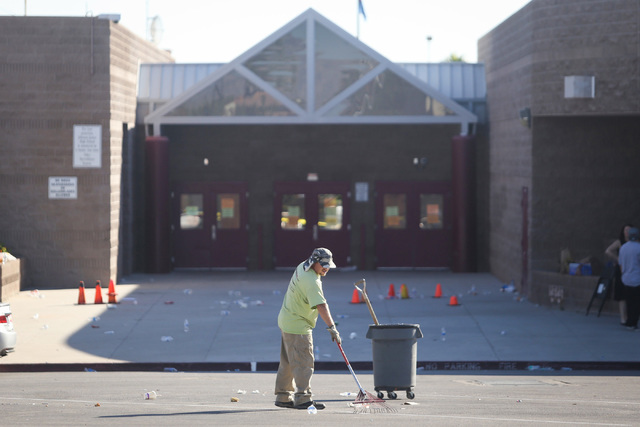 A worker cleans up trash left by parents at Walter D. Johnson Junior High School in Las Vegas on Thursday, Sept. 8, 2016. The school was closed on Wednesday after a student brought mercury to the  ...
