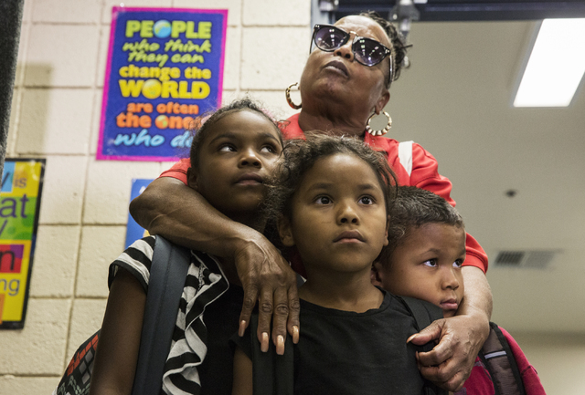 Denise Allen, middle, with Monica, Juliana and Ernesto Brown, listens to a briefing during a town hall meeting at Jacobson Elementary School on Thursday, Sept. 8, 2016, in Las Vegas. The Clark Cou ...