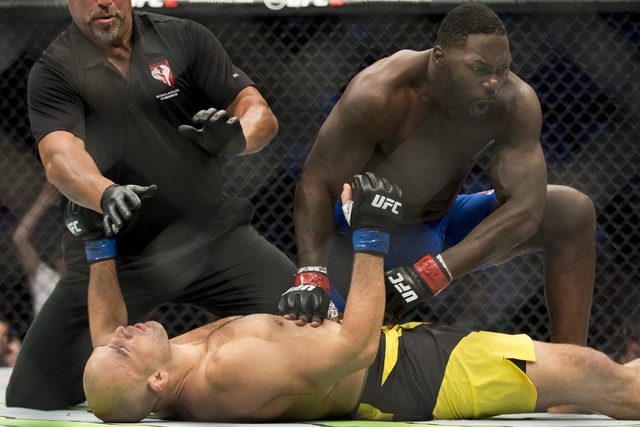 Anthony Johnson, top, finishes Glover Teixeira to win by a first round knockout in the light heavyweight bout during UFC 202 at T-Mobile Arena on Saturday, Aug. 20, 2016, in Las Vegas. (Erik Verdu ...