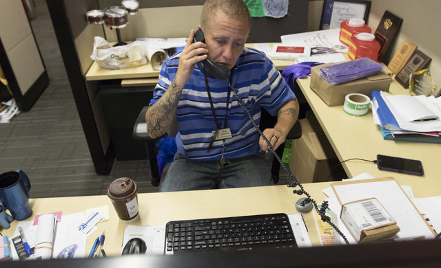 Blue Montana, transgender program manager at The Center, takes a phone call Aug. 29. Richard Brian/View