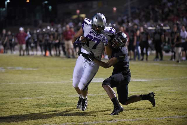 Silverado's Devin Ross (87) scores atouchdown against Desert Oasis Jason Sanders (9) during their football game played at Desert Oasis football field in Las Vegas on Friday, Sept. 9, 2016. (Martin ...