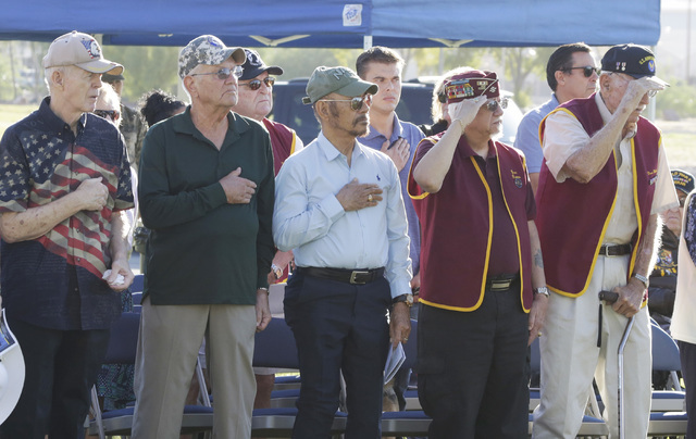 Ex-Prisoners of War, including Dean Whitaker, right, and Gene Ramos, second right, salut during the national anthem during the annual National POW-MIA Recognition Day ceremony Friday, Sept 16, 201 ...