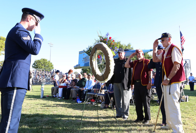 Ex-Prisoners of War, Dr. Marvin Carter , left, Gene Ramos, Dean Whitaker, Col. Samantha Weeks and Gene Ramos, right, salut during a wreath laying ceremony at the annual National POW-MIA Recognitio ...