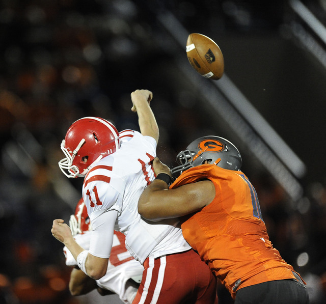 Bishop Gorman's Haskell Garrett, right, knocks the ball out of the hands of Brophy Prep quarterback Cade Knox (11) in the first half of the Sollenberger Classic on Friday. (Josh Holmberg/Las Vegas ...