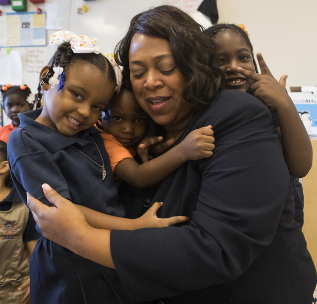 Mariah Wilson, from left, Lyris Miles, and Dylan Allison, all 4, hug Deputy Assistant Secretary with the U.S. Department of Education Monique Chism at Mater Academy of Nevada in Las Vegas on Thurs ...