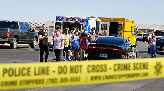 Emergency personnel stand by near Rainbow Blvd. in Las Vegas, Sunday, Sept. 25, 2016, after a shooting inside a Starbucks at a southwest valley strip mall.  (Chitose Suzuki/Las Vegas Review-Journal)