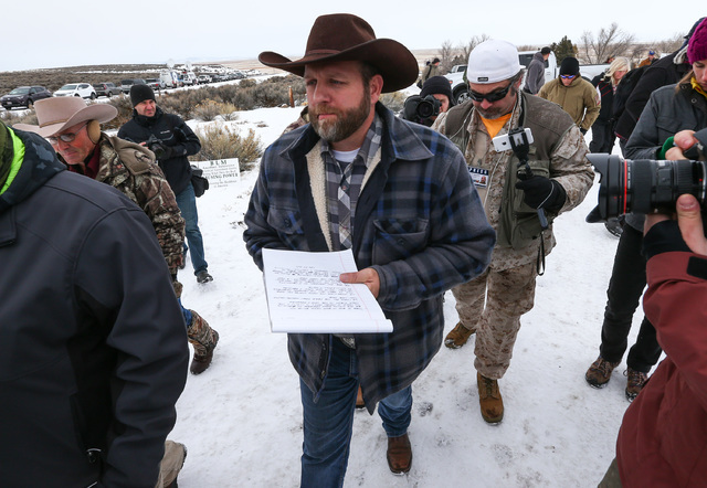 Ammon Bundy, center, prepares to speak as he is followed by conservative radio host Pete Santilli at the Malheur National Wildlife Refuge headquarters, occupied by anti-government protesters, near ...