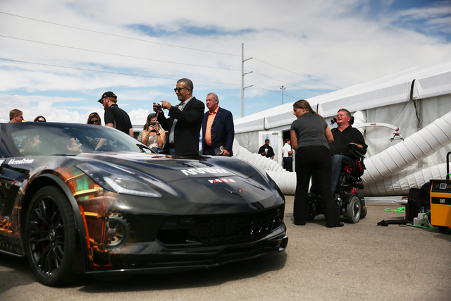 Sam Schmidt, right, prepares for a press conference after completing a test run in his modified Corvette at Exotics Racing on Wednesday, Sept. 28, 2016, in Las Vegas. Schmidt is the first person i ...