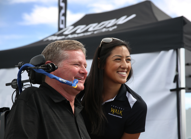 Sam Schmidt, left, poses for a photo with Samantha Okumura at Exotics Racing on Wednesday, Sept. 28, 2016, in Las Vegas. Schmidt is the first person in the country to receive a restricted driver's ...