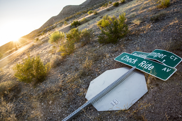 A fallen street sign marking Puddle Jumper Court and Check Ride Avenue at Searchlight Airpark subdivision on Sunday, Sept. 4, 2016, in Searchlight, Nev. (Benjamin Hager/Las Vegas Review-Journal)